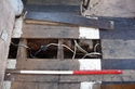 Thumbnail of The top of the bridging beam in the kitchen showing former joist sockets, looking south. 1m scale.