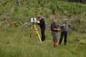Thumbnail of Andrew White, Stuart Jeffrey and Alastair Rawlinson producing a laser-scan survey of the Lephinkill chambered cairn. <br/> (ColGlen_production_images_01.jpg)