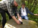 Thumbnail of Stuart Jeffrey of the Digital Design Studio, Glasgow School of Art, and Eamon Connon from the CGDT history and archaeology group, examining the Lephinkill rock-art. <br/> (ColGlen_production_images_02.jpg)