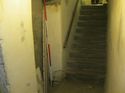 Thumbnail of View looking up stairwell from basement level. Note former opening now in filled to south wall