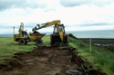 Thumbnail of Machine stripping topsoil and revealing extent of 2000 excavation