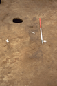 Thumbnail of Remains of  phase 3 timber stain (029) facing south east with excavated posthole (051) next to it (scale 50cm)