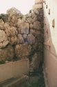 Thumbnail of <em>View of the lower courtyard, showing westernmost metopes re-used as revetment slabs and Mycenaean wall.</em> <br  />(op000009.jpg)
