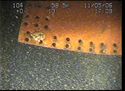 Thumbnail of Steel plate with holes for rivets; still from video