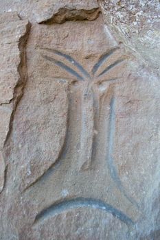Photograph of a petroglyph in the form of a human face at Avencal 1