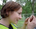 Thumbnail of Site Supervisor, Katherine Fennelly, inspects the clay pipe bowl with skull and cross-bones.