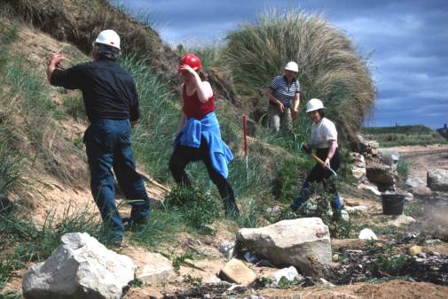 Figure 42: Clyne Heritage Society members working at an eroding structure on the beach at Brora, Sutherland.