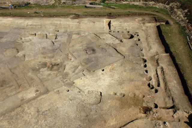 Photograph of a LEAP project excavation. Early Roman Timber Building 1 at the intersection of the streets; views from the south