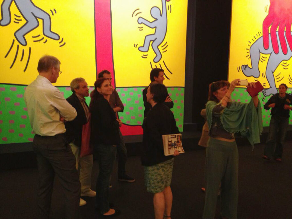 Photo of partners enjoying the Keith Haring exhibit presented by host partner CentQuatre in Paris.