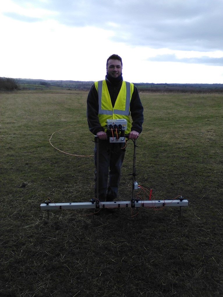 A picture of Chris Whitakker undertaking geophysical survey