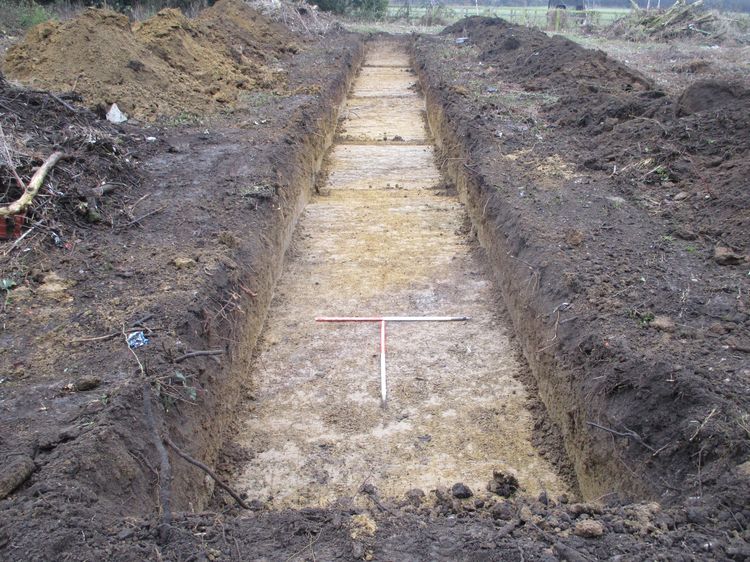 Trench with dark organic material around it