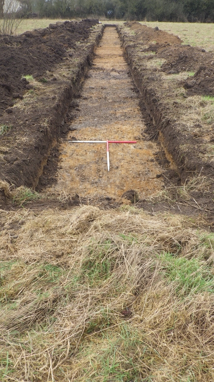 Trench with dark and light brown soil
