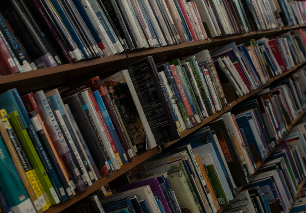 Image of books on a shelf of a library