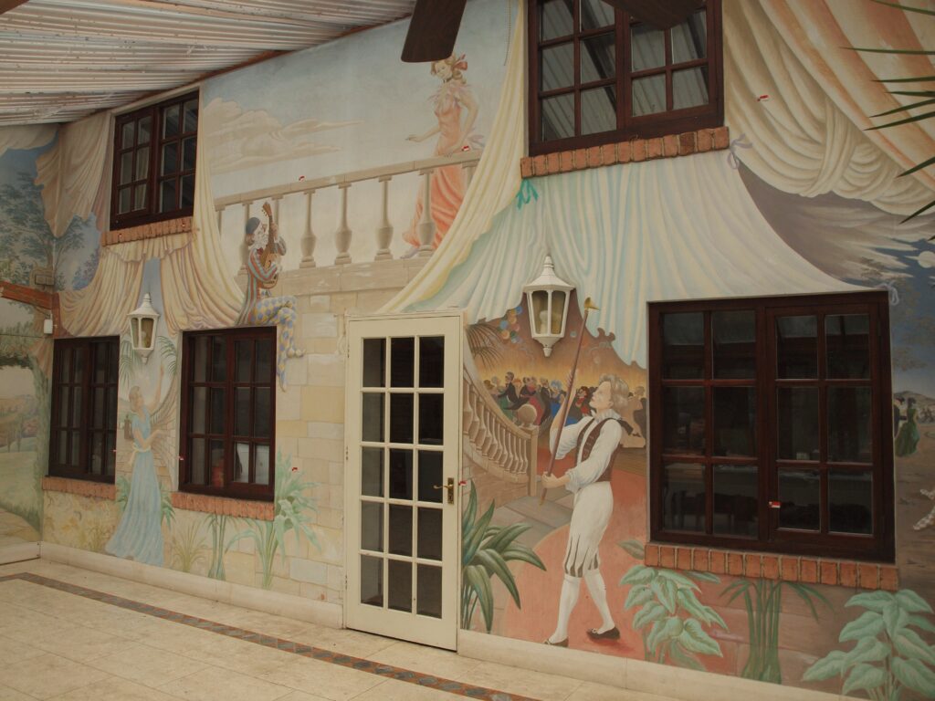 Shot of the 1986 Timothy Plant mural titled The Sad Tale of Pierrot, from the right side