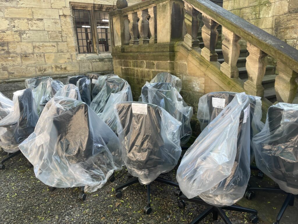 A picture of the delivery of chairs outside the ADS office