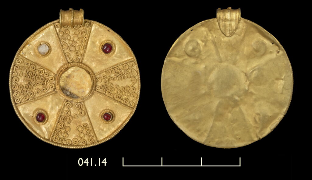 A photograph of a gold disc pendant