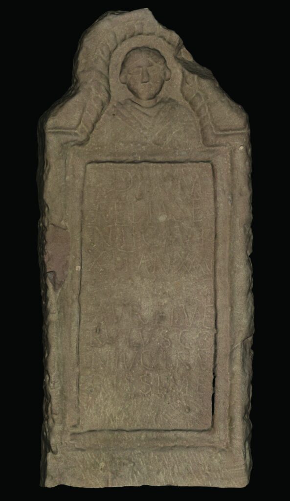 A 3D image of a tombstone with a face at the top