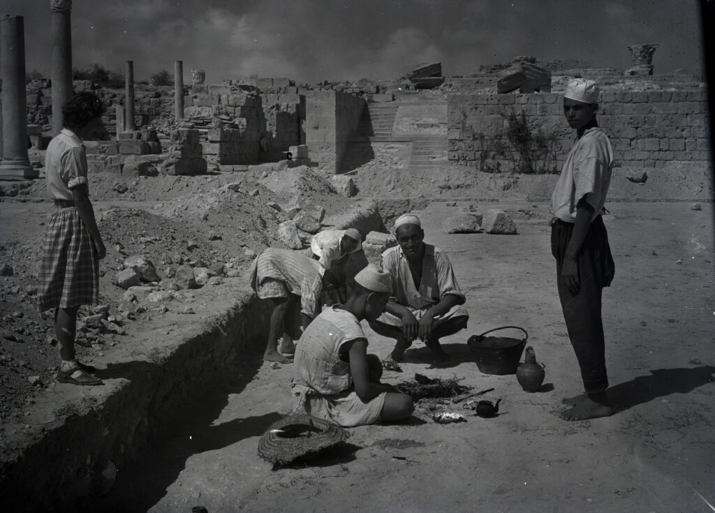 Black and white photo showing a group making tea within the excavation site