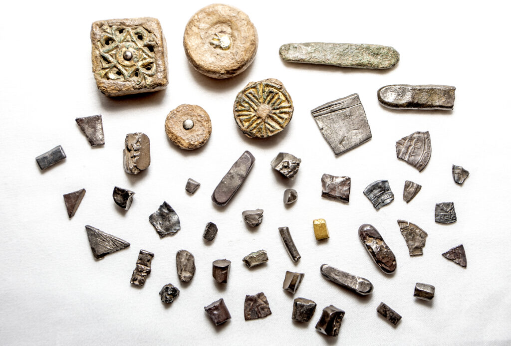Pieces of metal artefacts on a white background