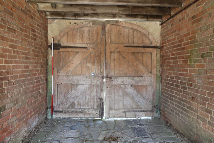 Thumbnail of Figure 11 and 39 Double doors to coach-style archway looking north