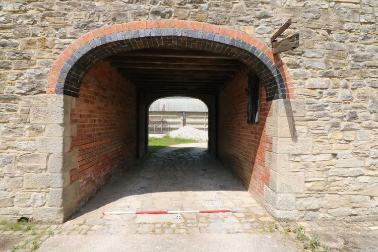Thumbnail of Figure 9 and 40 coach-style archway viewed from the courtyard looking north