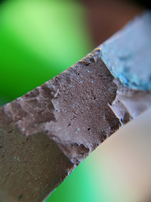 Photograph of the profile of a <em>terra sigillata</em> sherd at 20x magnification, showing detail of the fabric.