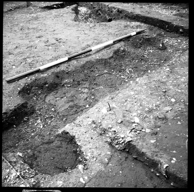 Thumbnail of 67-12 Close up looking NW of sections of foundation trenches in IDX with scale