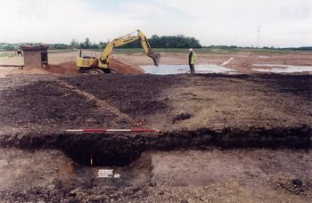Iron Age boundary ditch flanked by the remains of a sandy clay and gravel bank sealing a buried soil of dark brown silty clay loam above a clayey peat. © York Archaeological Trust, on behalf of Tarmac