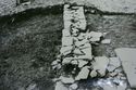 Thumbnail of 1968 black and white photograph showing footings of stone wall, West Front.