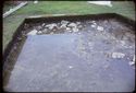 Thumbnail of 1974 photograph of trench in Site XXIII (Outer Courtyard), showing waterlogged stone scatter.
