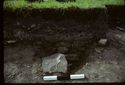 Thumbnail of 1974 photograph of trench in Area B, Site XXIII (Outer Courtyard), showing section of pit and stones.