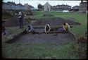 Thumbnail of 1974 photograph of trench in Site XXIII (Outer Courtyard), looking west, showing several archaeologists removing baulk between trenches.