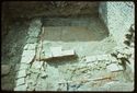 Thumbnail of 1976 photograph of Site XIII (Inner Courtyard), looking south, showing wall and drains of room behind Tower A.