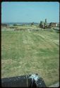 Thumbnail of 1976 photograph across the site from Turret House, looking east, showing Trenches XIII-XV (Inner Courtyard), West Front, and standing buildings on South Range.