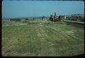 Thumbnail of 1976 photograph across the site from Turret House, looking east, showing Trenches XIII-XV (Inner Courtyard), West Front, and standing buildings on South Range.