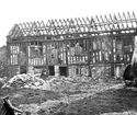 Thumbnail of Black and white photograph showing ruins of Long Gallery, and rubble.