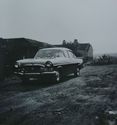 Thumbnail of Black and white photograph, c.1960s, showing Cruck Building behind car. Handwritten text reads: 