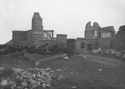 Thumbnail of Black and white photograph, looking south-east, showing ruins of buildings at South Range, and rubble.
