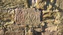 Thumbnail of The Roman inscription on the east face of the wall, with illegible characters or marks above ‘LEG VI’
