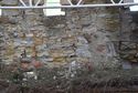 Thumbnail of Daylight is visible between the stones of the south parapet and there is another crude repair below the scale