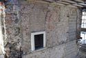 Thumbnail of The west face of the new passage contains a mixture of brick and stone, with a modern fireplace and arched passage