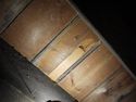 Thumbnail of North bay. Underside view of floor boards, where a metal (?iron) tongue is exposed in a split board. Facing NW