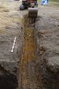 Thumbnail of Working shot of machine excavating Trench 3, viewed from the East South East. 1x1m scale
