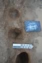 Thumbnail of Post-excavation shot of Postholes [1205] and [1207] (0.2m scale)