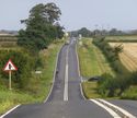 Thumbnail of Figure 24: the B6265 looking north-west towards Aldborough along the line of Dere Street (Margary road 8a).