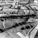 Thumbnail of Figure 43: north-facing aerial photograph of Cataractonium (taken in 1949) showing Dere Street (Margary road 8b) entering the south gate of the town, past the forts to the immediate west, and extending northwards (Margary road 8c) on the north bank of the river. (Cambridge University Collection DQ-80; © Crown Copyright/MOD).