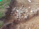 Thumbnail of Cleaned Area (1102) showing pottery and quern stone Area B
