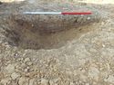 Thumbnail of E. facing section of Pit [1100]. Section 61 Area B