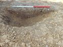 Thumbnail of E. facing section of Pit [1100]. Section 61 Area B
