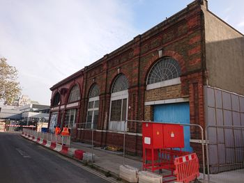 North-western elevation of 16-17 Melton Street (former London Underground entrance) viewed from the west on Drummond Street towards Euston Station.